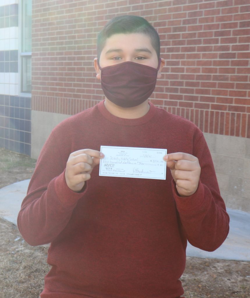 Student holding grant check.