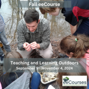 Instructor in an outdoor setting surrounded by students is looking at small insects.