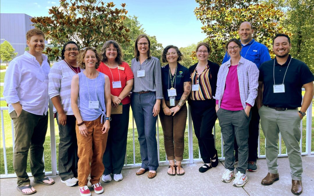 Ten adults standing in a line.