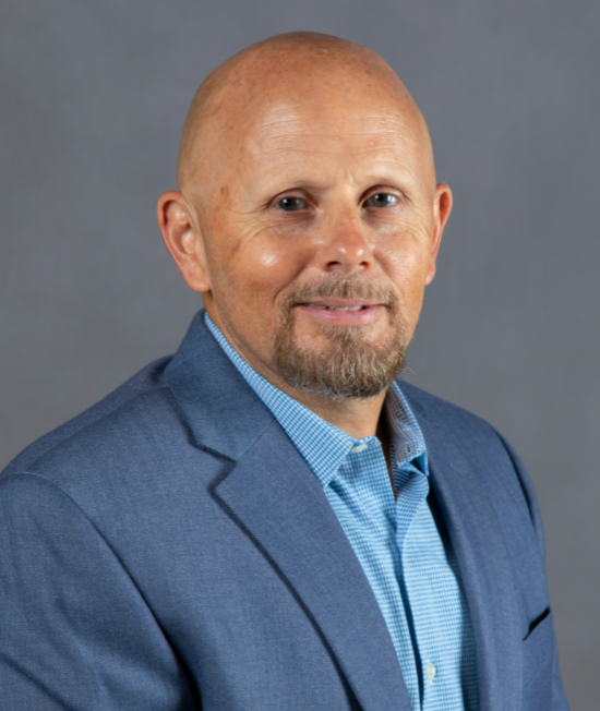 Man wearing a blue jacket and blue shirt