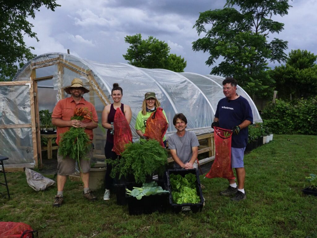 garden workers showing off produce