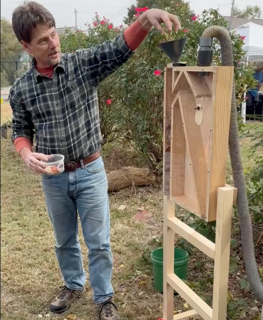 man demonstrating gardening tool
