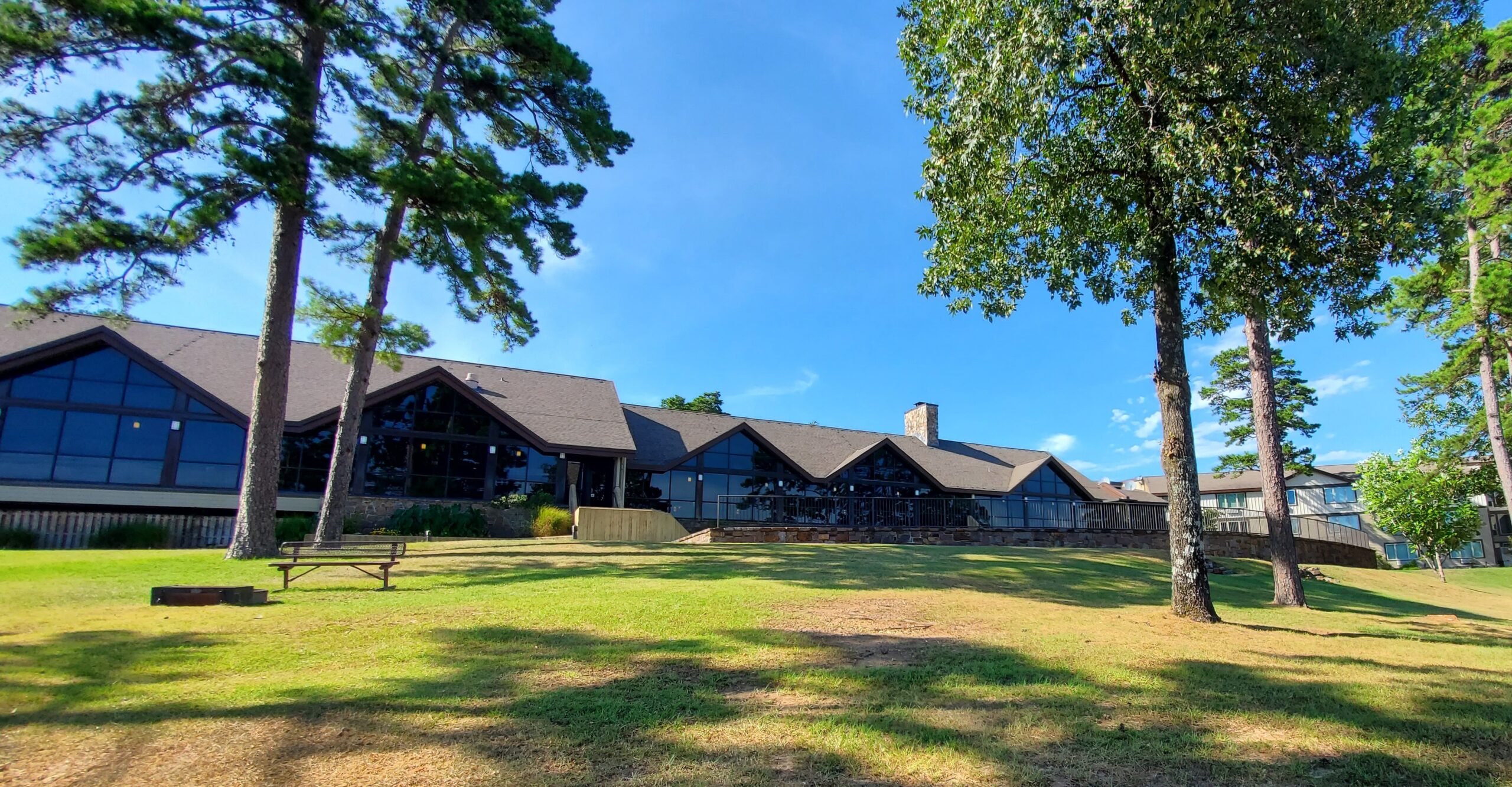 outside of lodge with lawn and trees.